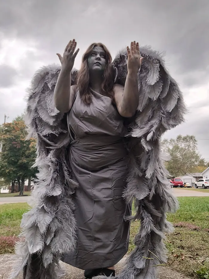 Jordan in a gray winged statue costume