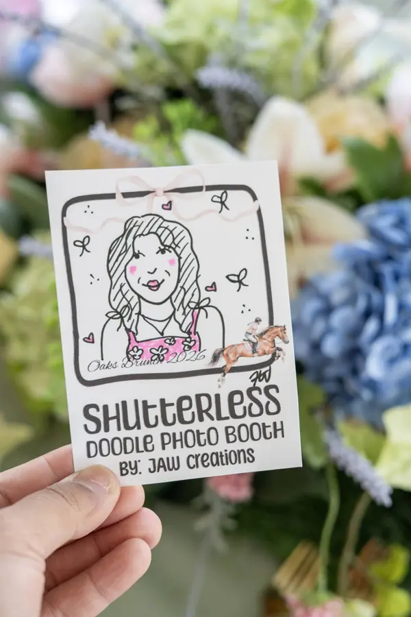Doodle portrait held up in front of wedding flowers