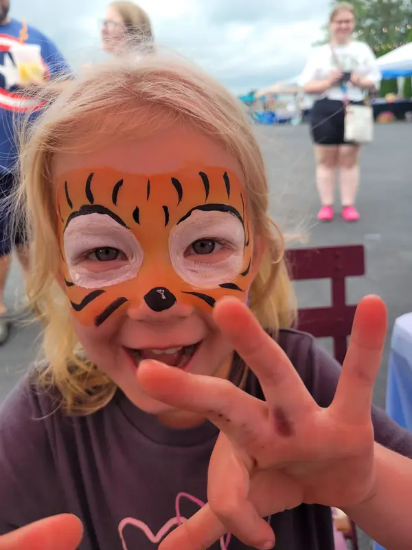 Child with a tiger face paint design