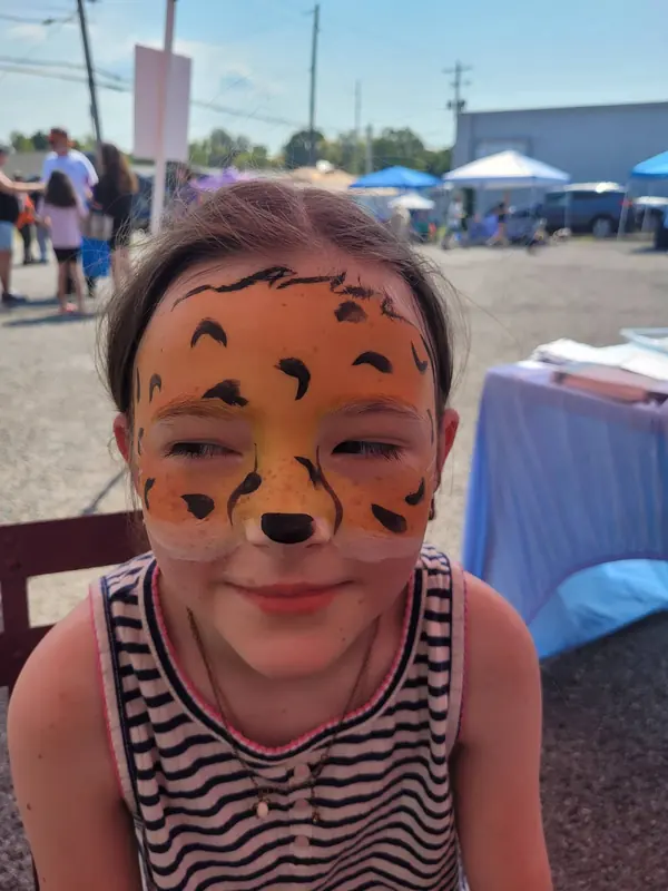 Child with a leopard face paint design