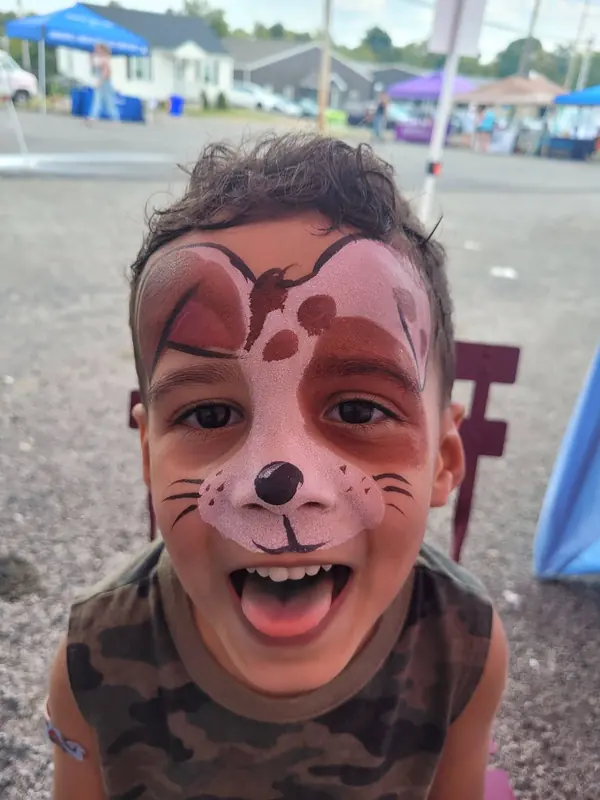 Child with a puppy face paint design