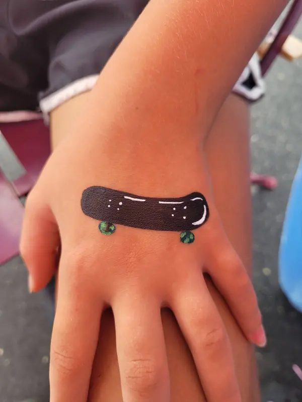 Skateboard painted on a hand