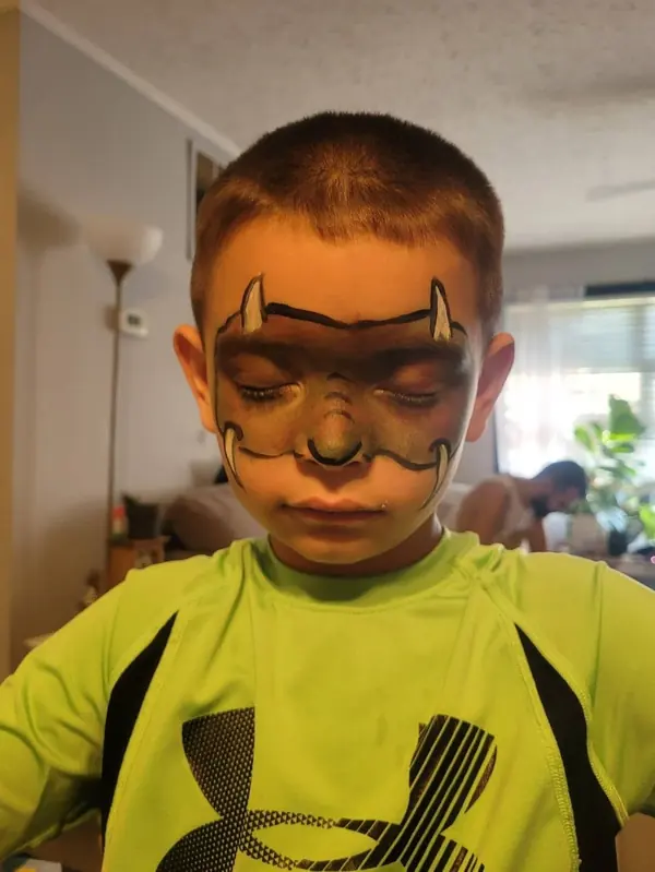 Boy with a horned bat mask face paint design