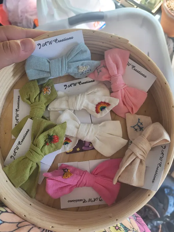 Basket of handmade hair bows with embroidered details
