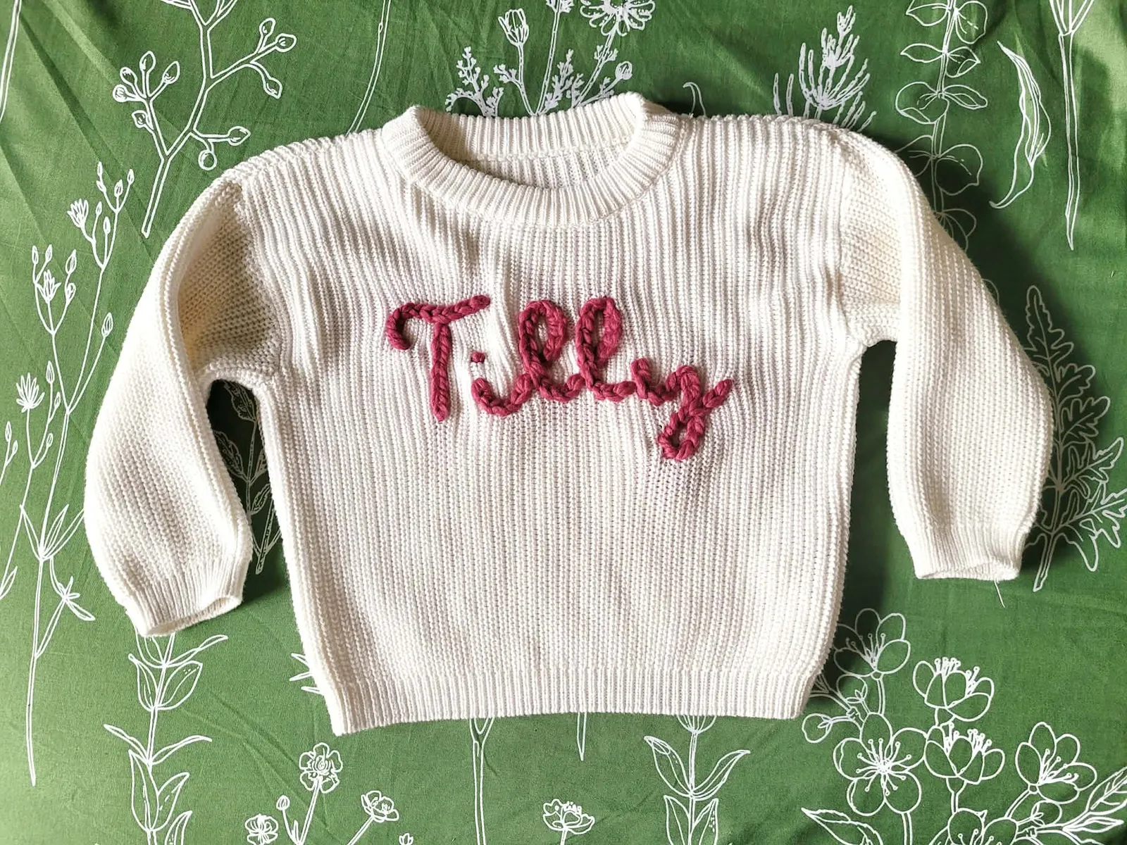 Cream sweater embroidered with the name Tilly