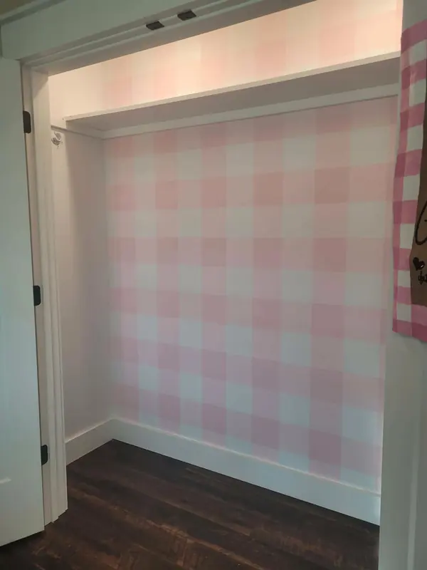 Closet painted in soft pink gingham
