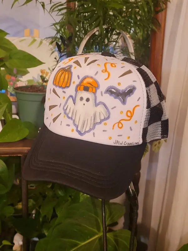 Trucker hat hand-painted with a ghost, pumpkin and bats