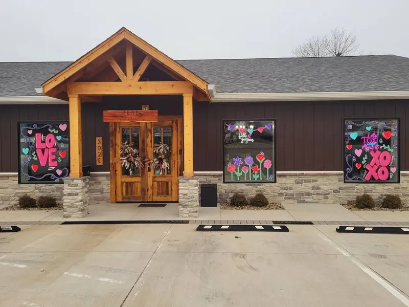 Valentine's window art across a timber-frame business