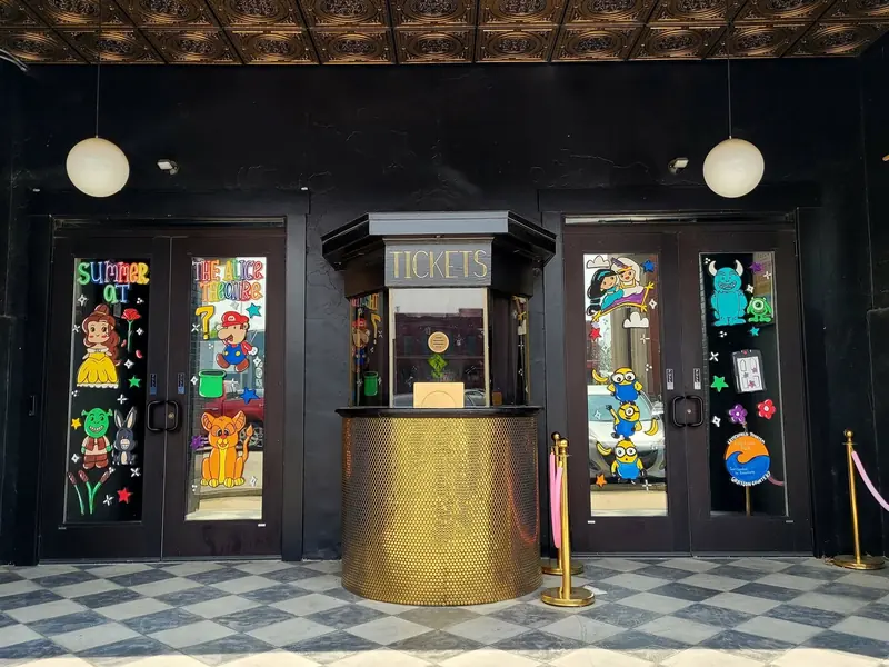 The Alice Theatre doors painted with colorful characters